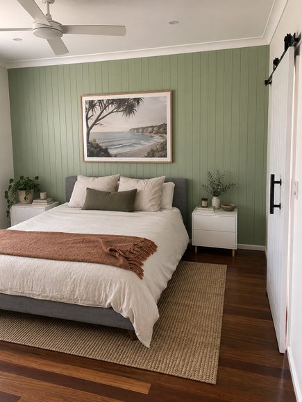 Green VJ panelled feature wall behind a bed