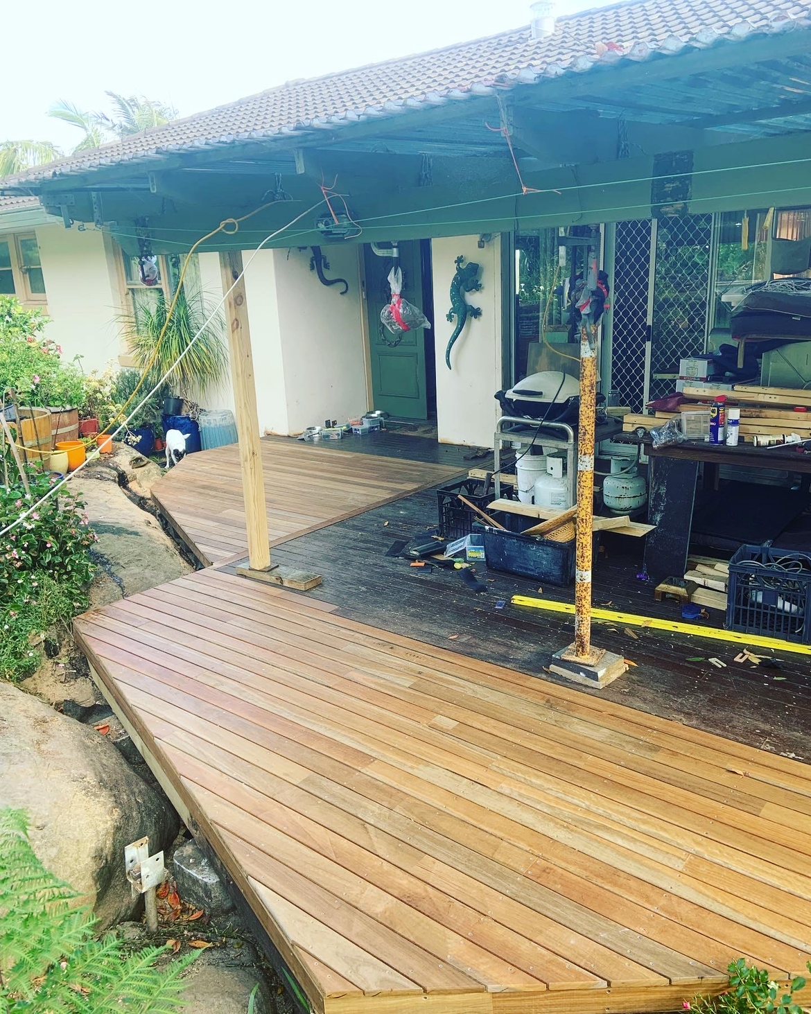 Deck under construction beside a green door