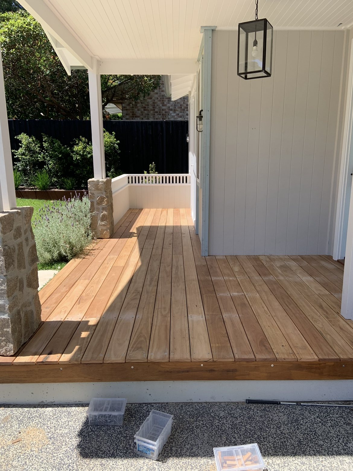 Deck and porch with stone pillar and lantern light