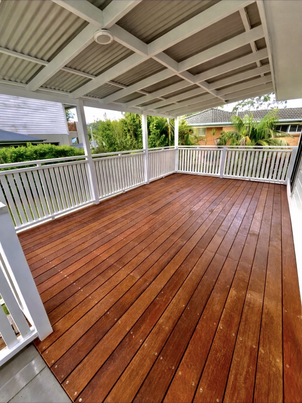 After: finished stained timber deck with white balustrade