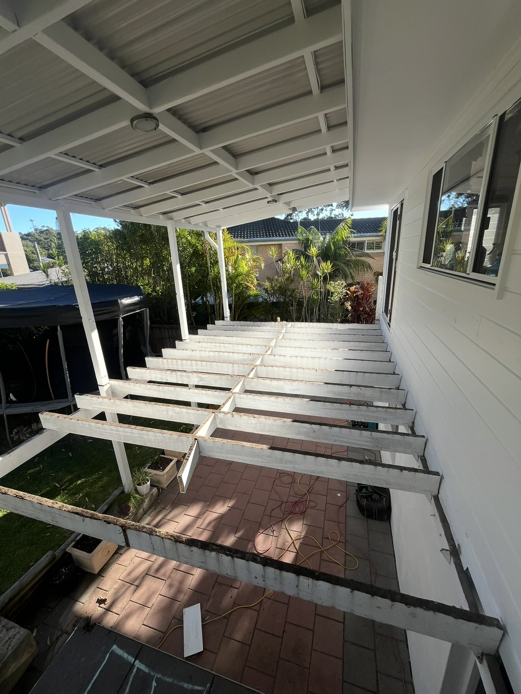Before: bare joist frame under an existing patio roof
