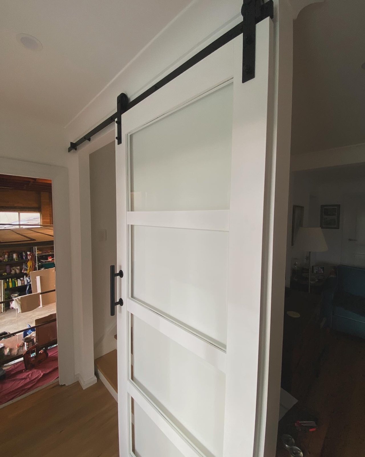 White sliding barn door with frosted glass panel