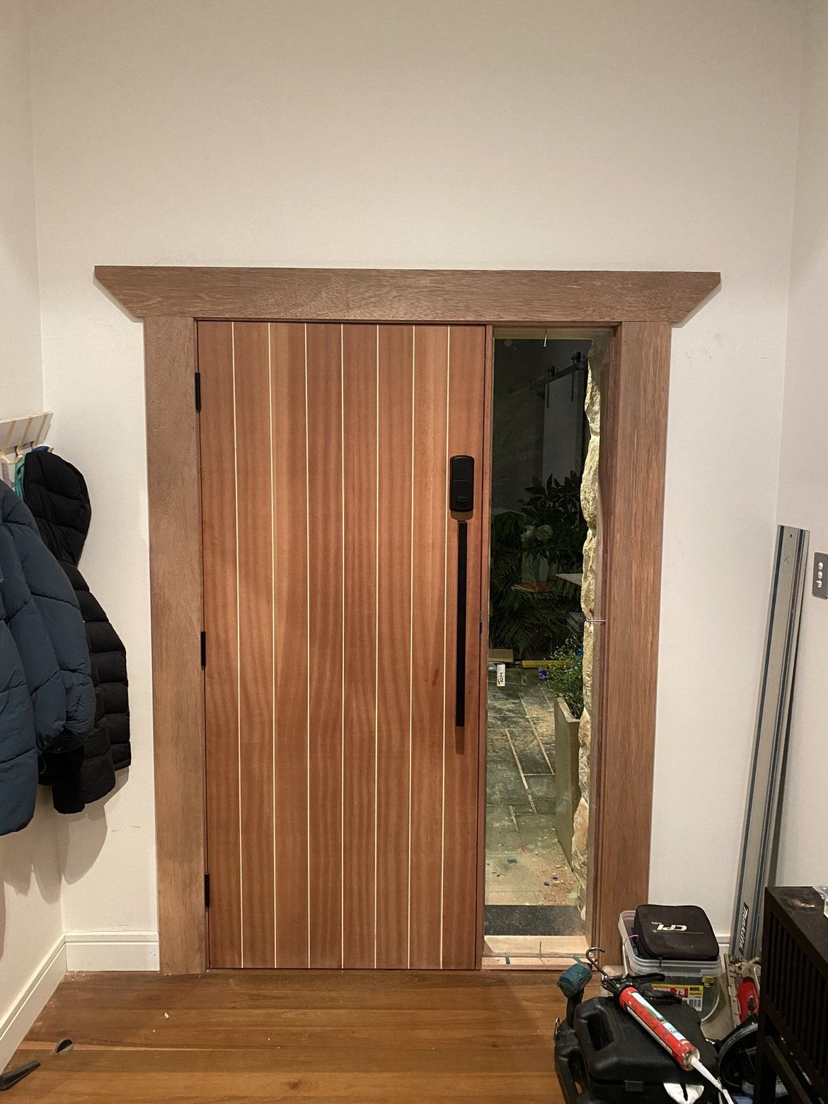 Mahogany slat door from inside, glimpse of the courtyard