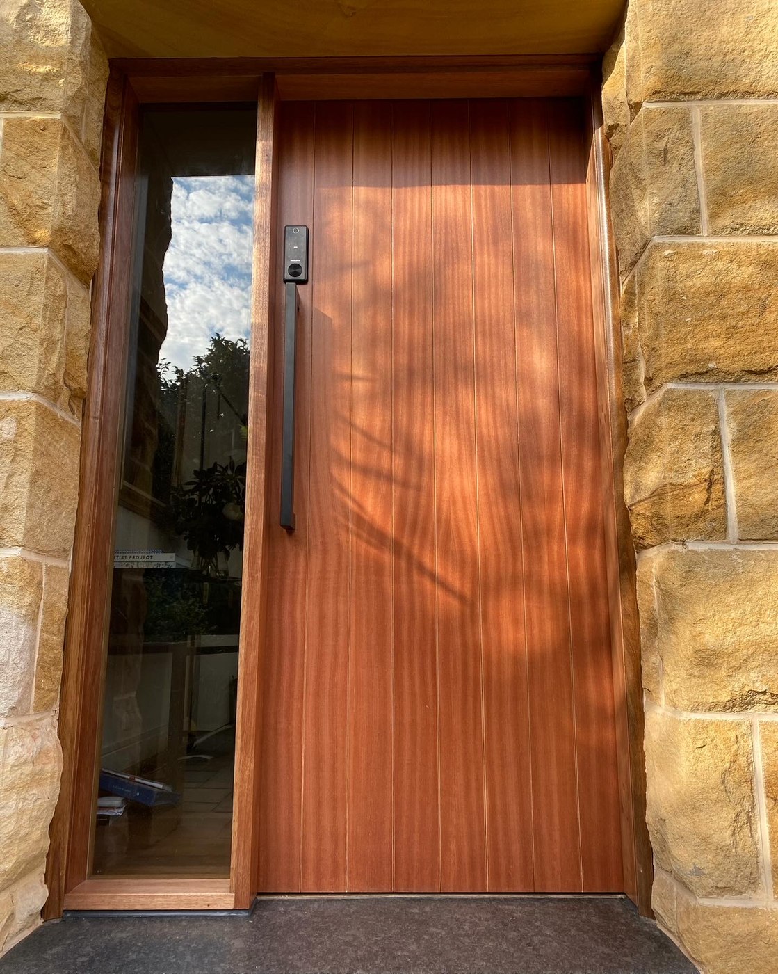 After: modern timber slat front door with glass sidelight