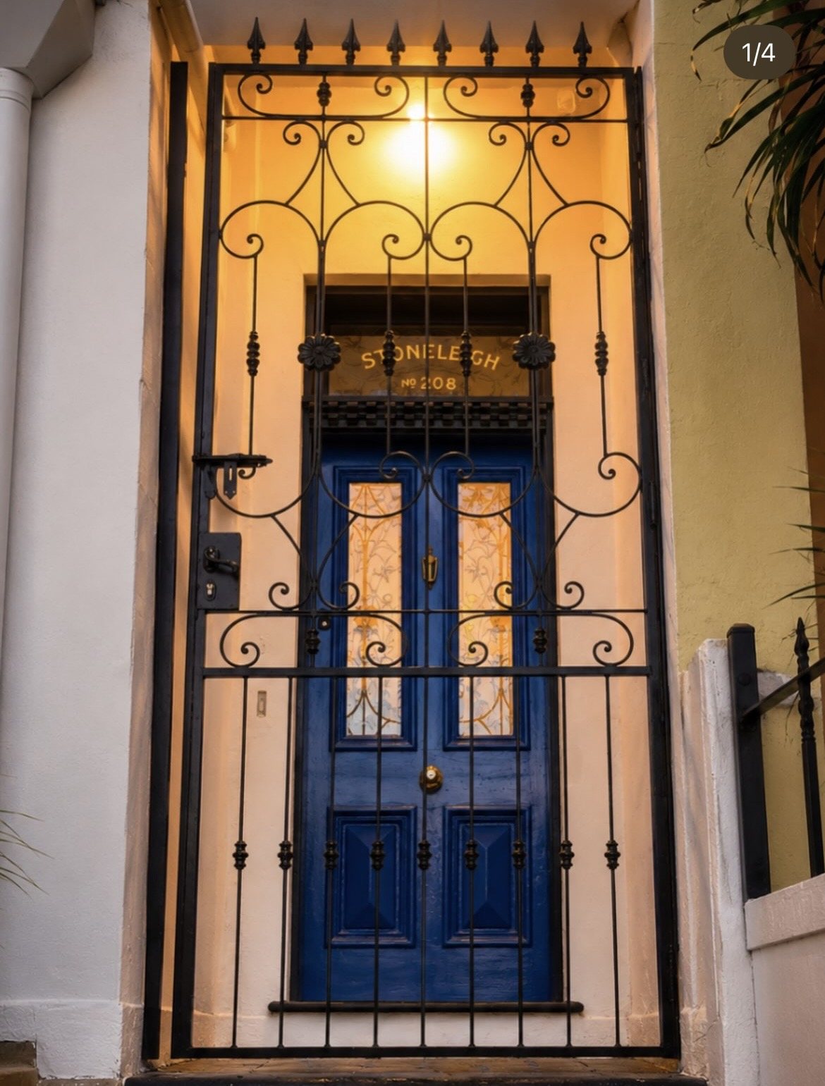 Blue Stoneleigh door behind an ornate iron gate