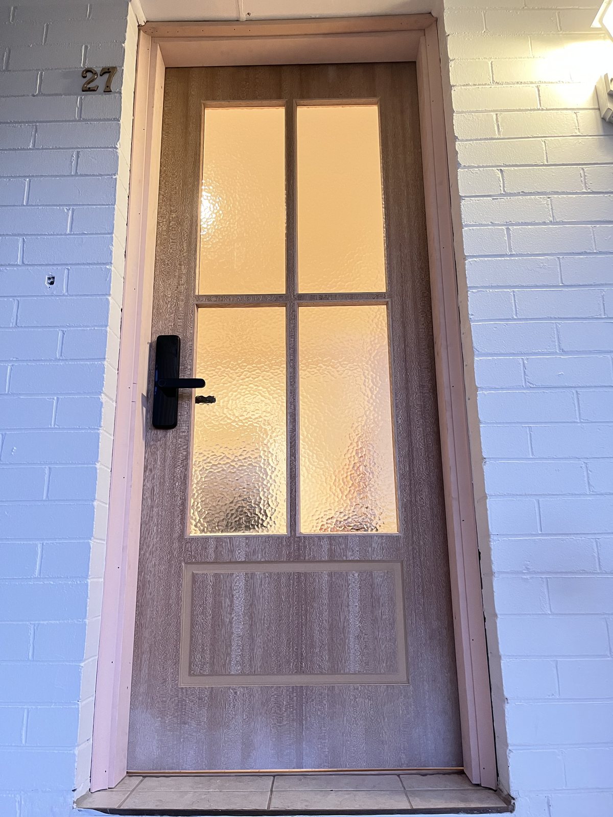 Timber-look door with glass panes, smart lock
