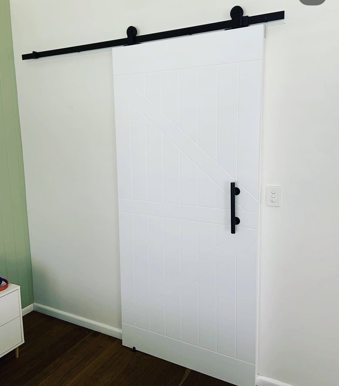 White sliding barn door with V-groove panel design