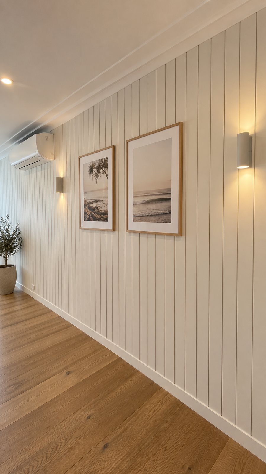 Sage green VJ panelled hallway with framed prints