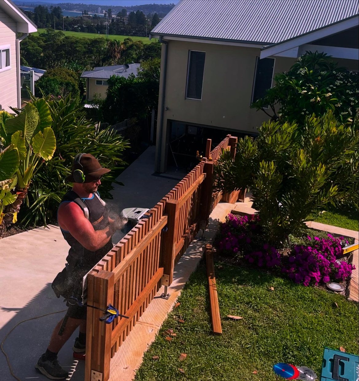 Carpenter building a slat gate, coastal property