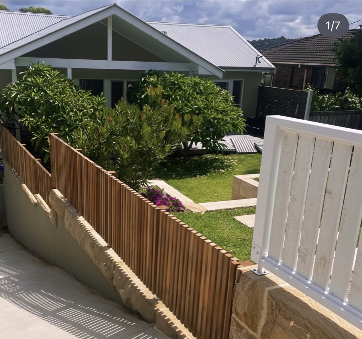 Spotted gum front yard fence with sandstone wall
