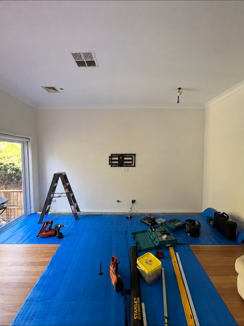 Before: room mid-renovation with flooring in progress