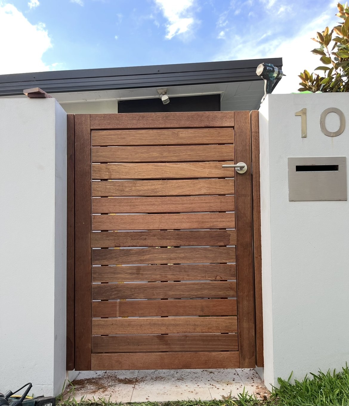 Slatted timber side gate with house number