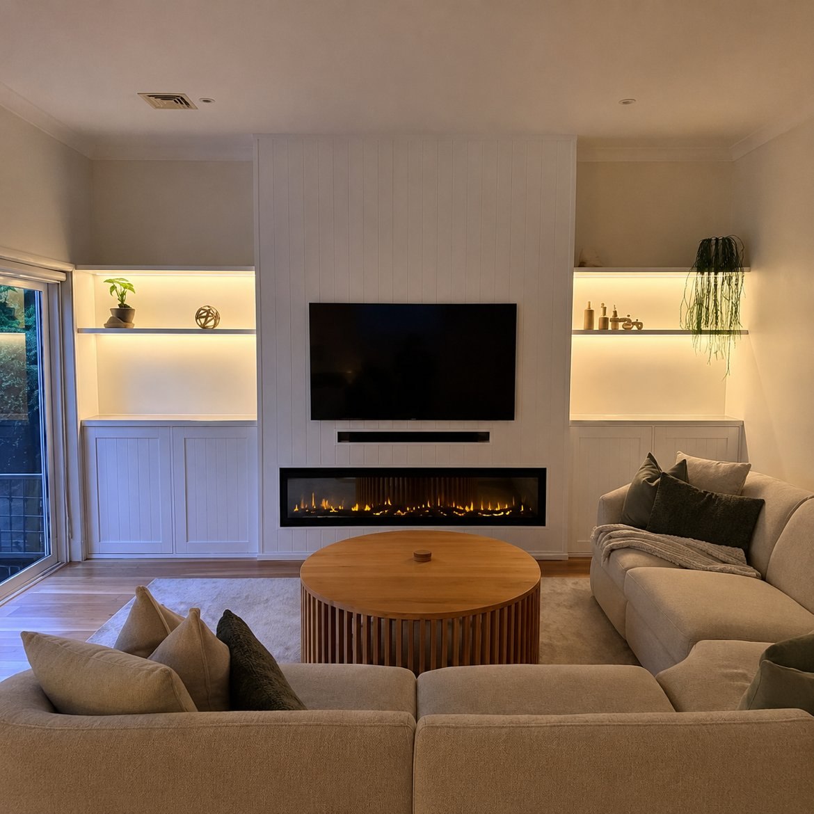 After: built-in media wall with fireplace and LED shelving