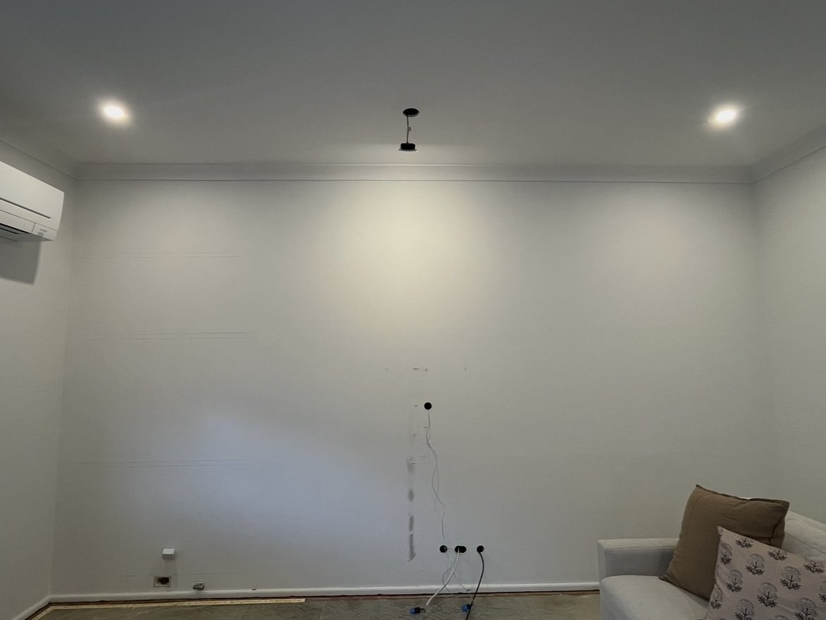 Before: bare wall prepped for a media wall