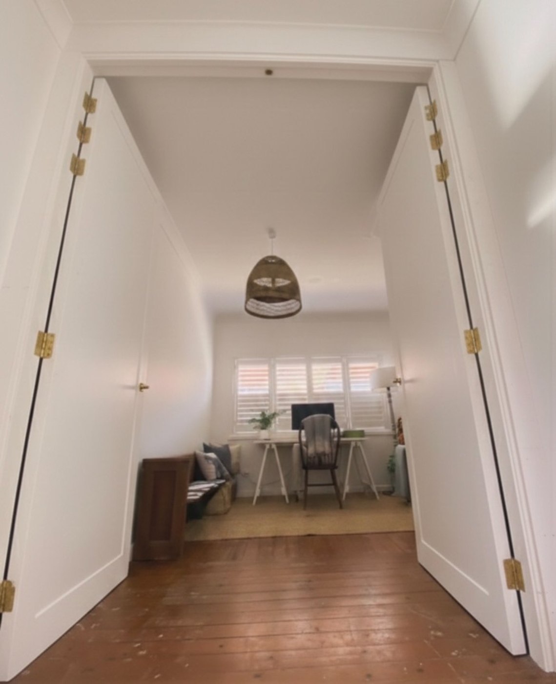 After: hallway view through double doors into the office nook
