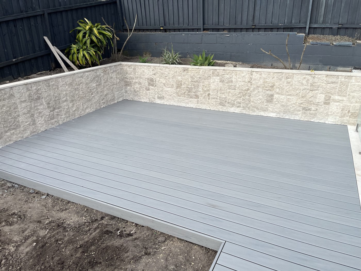 After: finished grey composite deck beside the pool