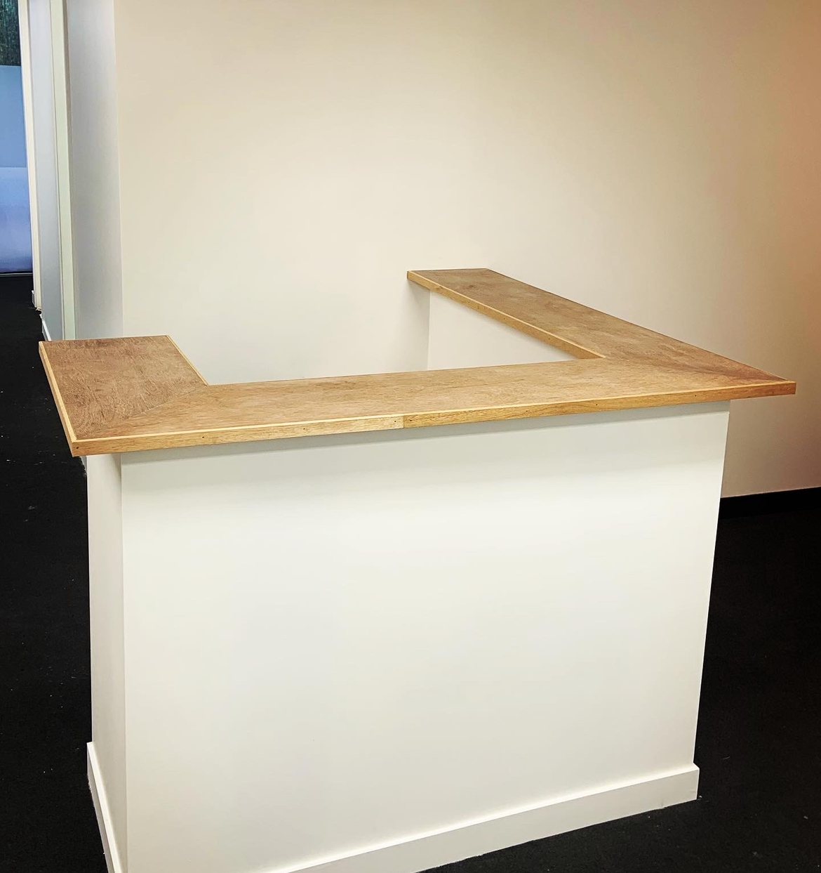Custom L-shaped reception desk, timber top