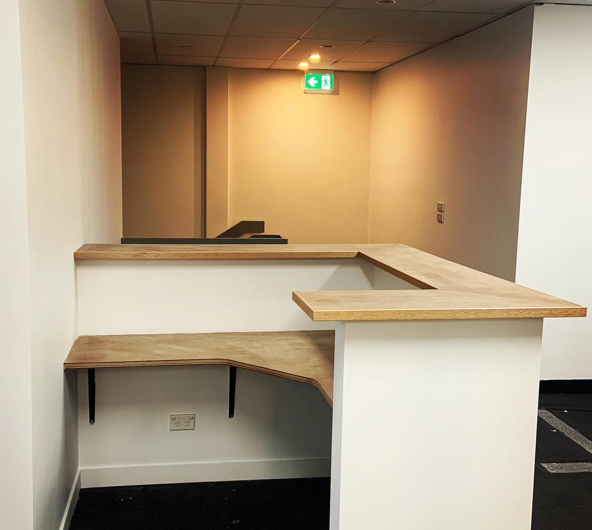 Custom L-shaped reception desk, rear angle