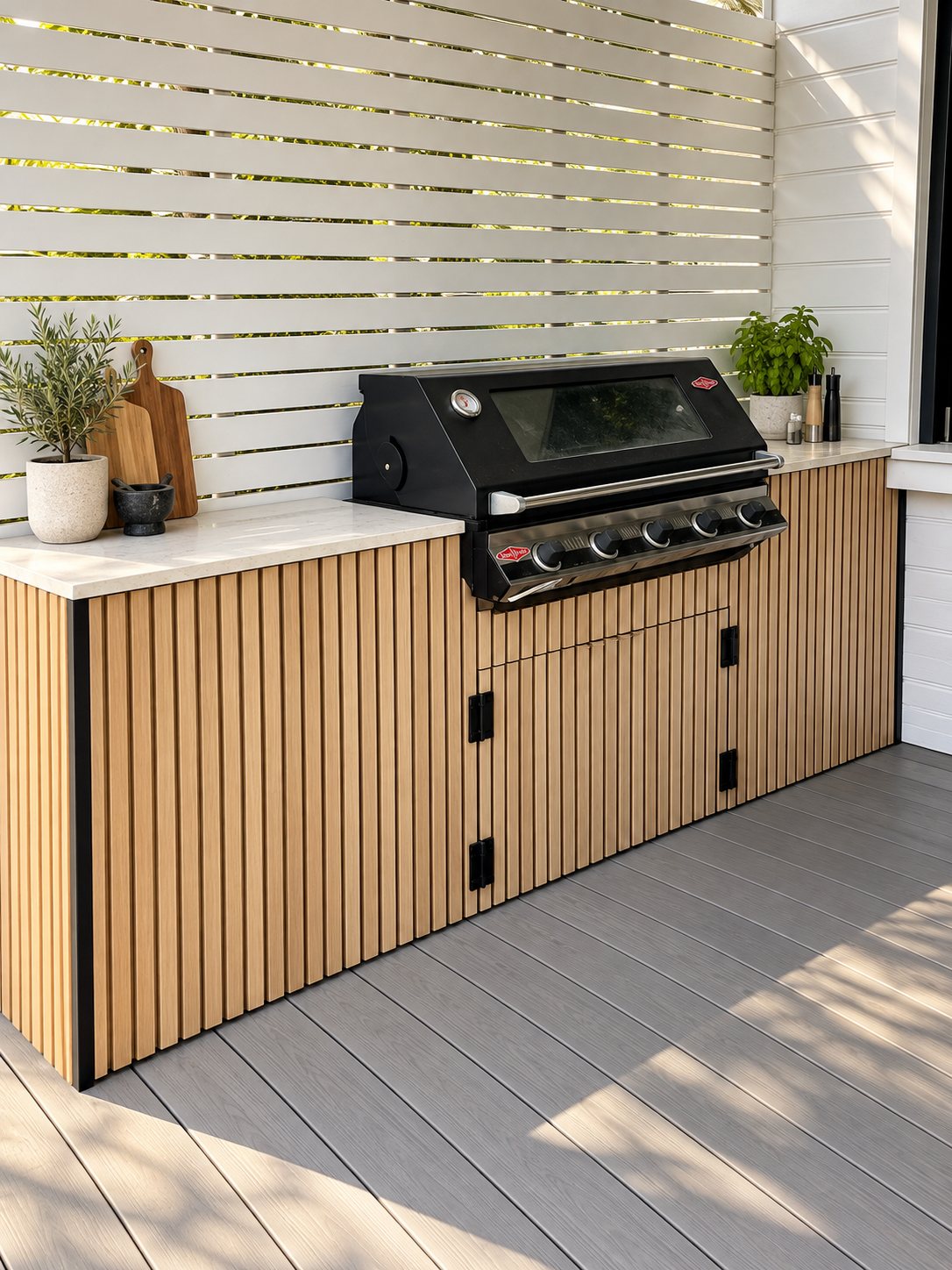 Outdoor kitchen with slat cabinetry and stone benchtop