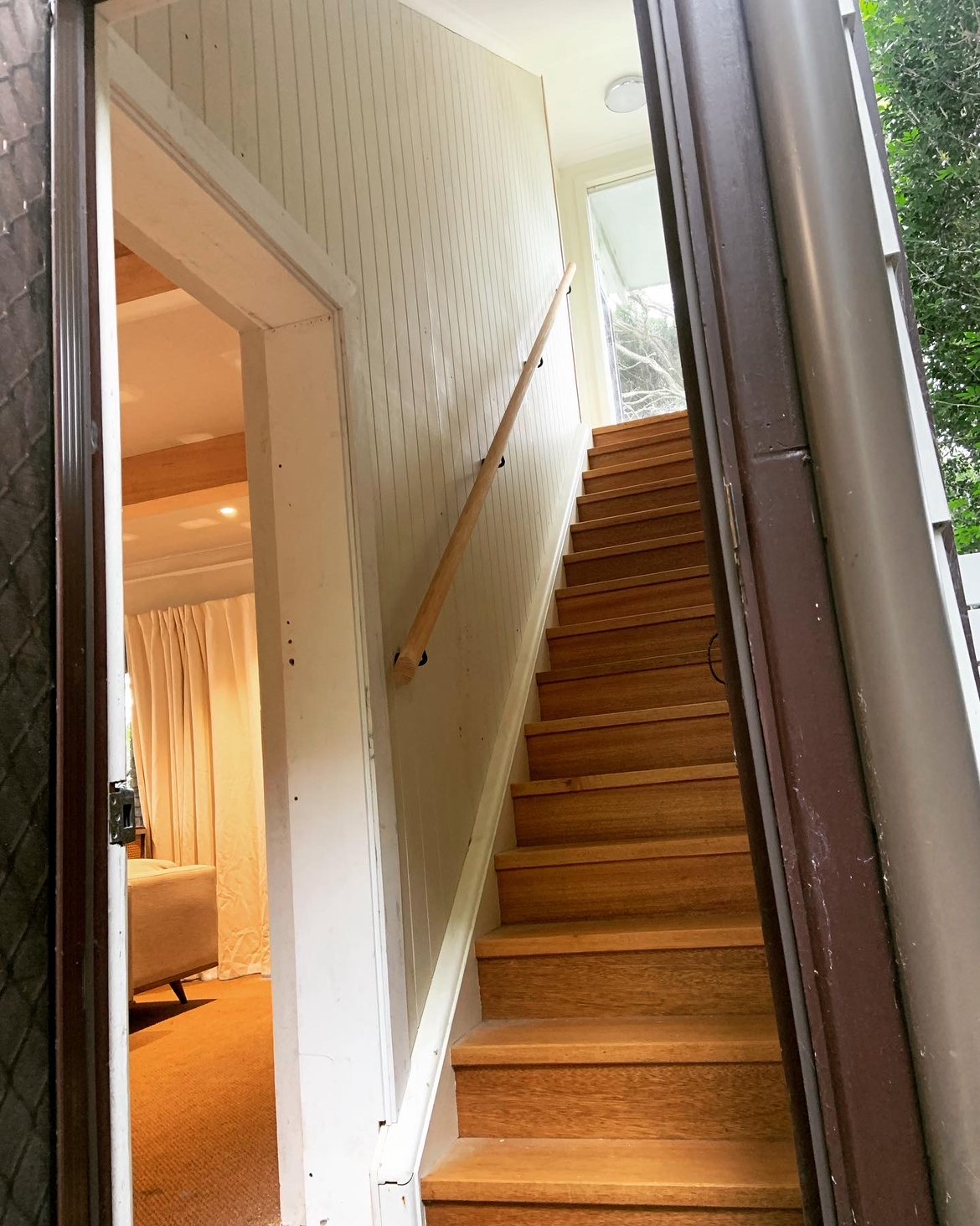 Timber staircase viewed through an open doorway