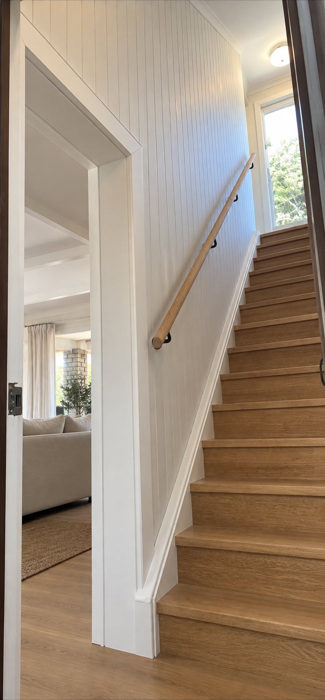 After: staircase with white VJ panelling and new timber treads