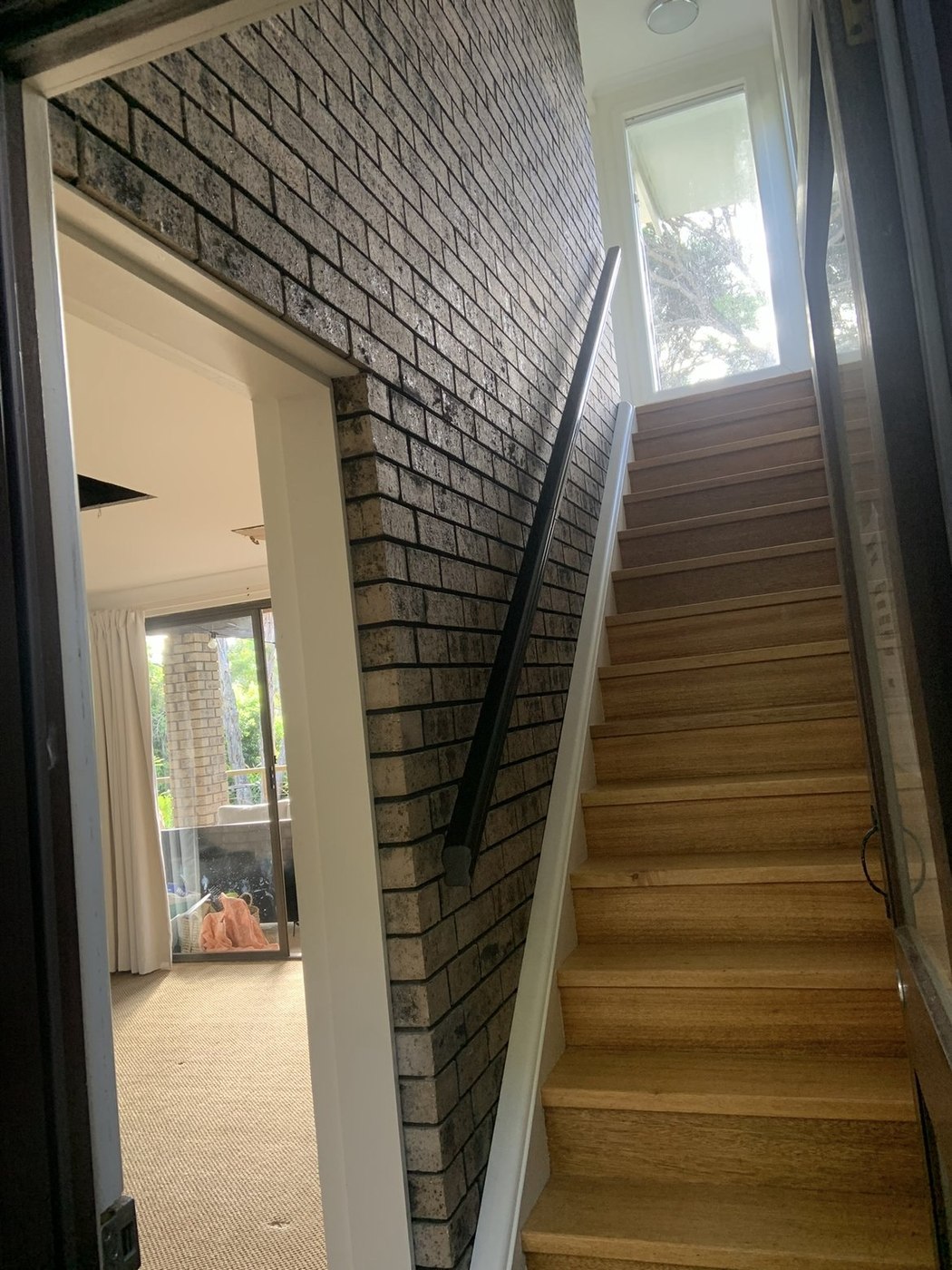 Before: original staircase with brick feature wall