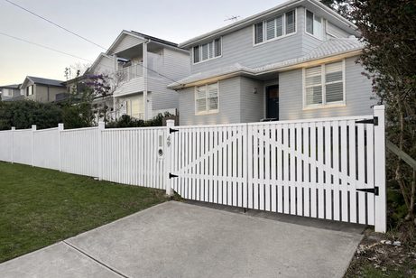 White picket driveway gate