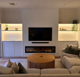 Media wall with integrated fireplace and LED shelving