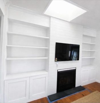 White built-in shelving with fireplace