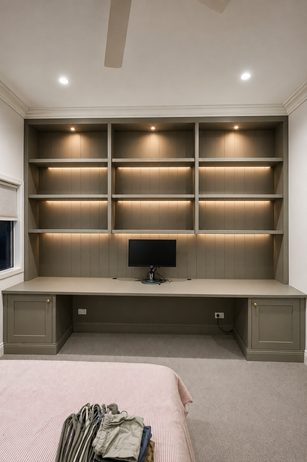 Built-in desk and media cabinetry with LED lighting
