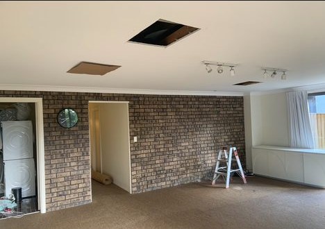 Before: dated brick feature wall room