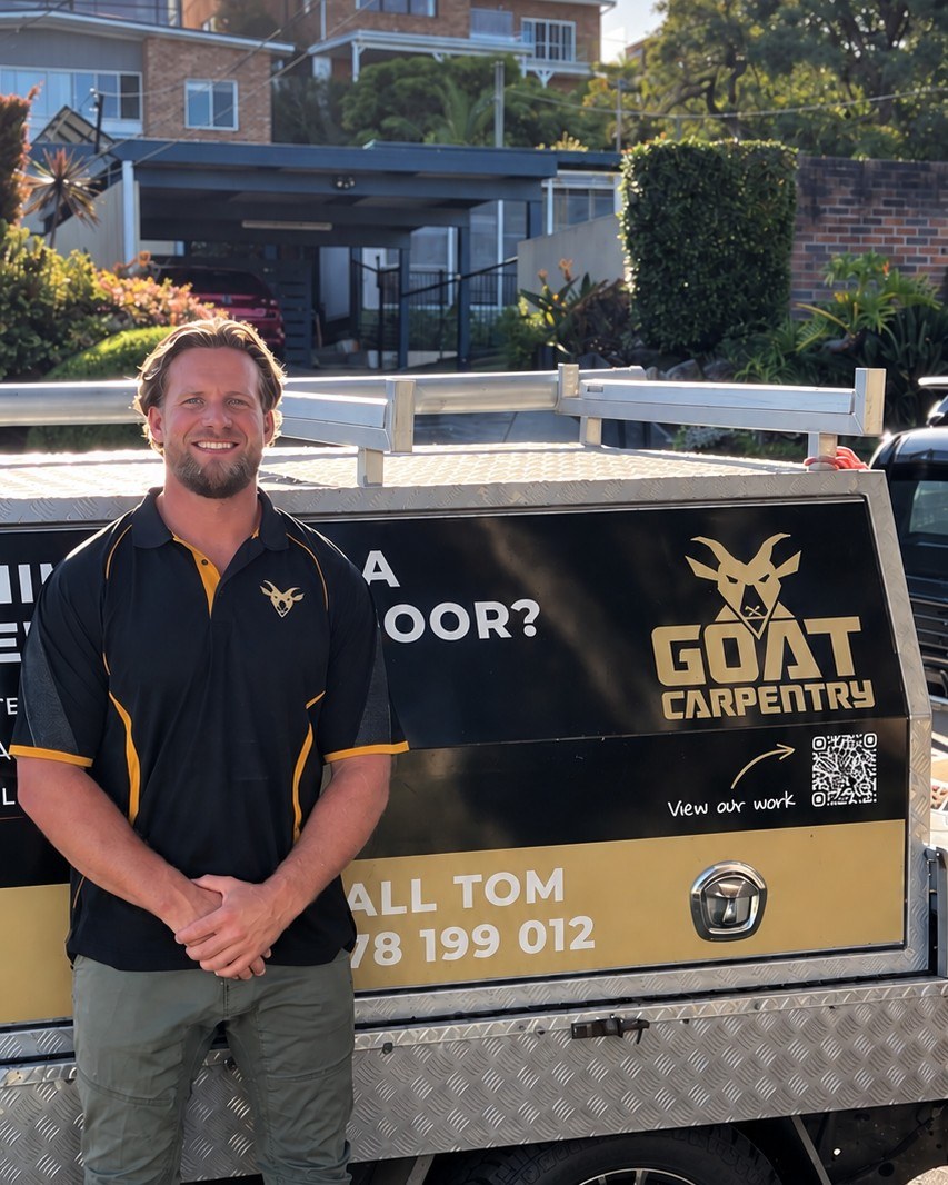 Tom, owner of Goat Carpentry, in front of his branded work ute